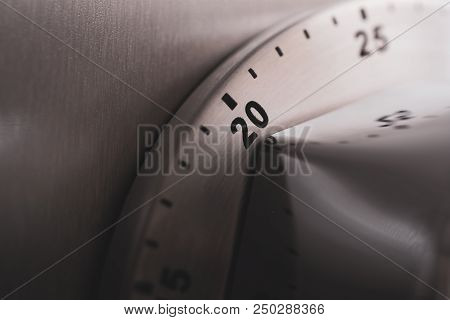 20 Minutes - An Analog Chrome Kitchen Timer Placed On A Refrigerator
