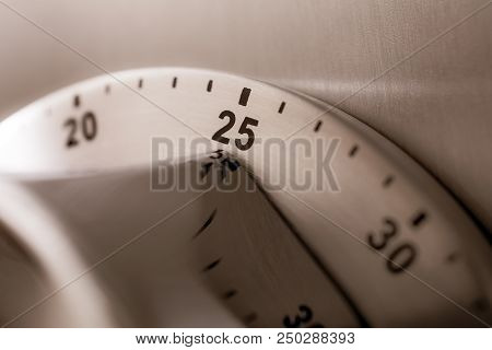 25 Minutes - An Analog Chrome Kitchen Timer Placed On A Refrigerator