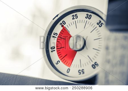 20 Minutes - An Analog Kitchen Timer With Red Mark Placed On A Shelf In Monochrome Colors
