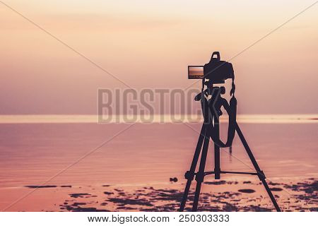 Dslr Digital Professional Camera Stand On Tripod Photographing Sea, Twilight Sky And Cloud Landscape