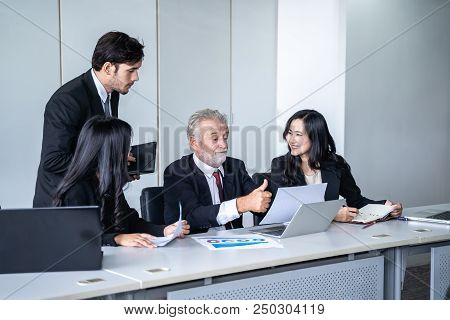 group of successful businessman. Discussion of the business profits of the company in meeting roon o