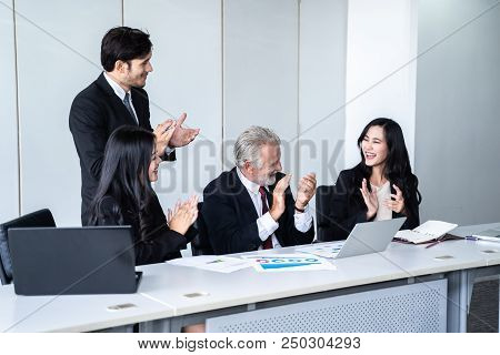 group of successful businessman. Discussion of the business profits of the company in meeting roon o