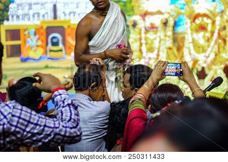 July 2018,durgapur, West Bengal, India. A Purohit Panda Blessing A Devotee With Holy Flowers At Rath