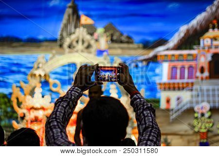 Durgapur, West Bengal, India. July, 2018 A Devotee Clicking Photo Of Idols Of Jagannath Balaram Suva