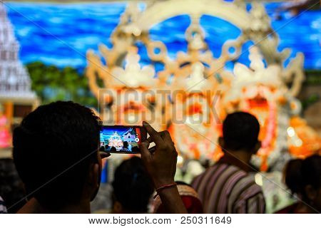 Durgapur, West Bengal, India. July, 2018 A Devotee Clicking Photo Of Idols Of Jagannath Balaram Suva