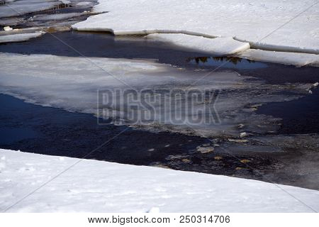 The Awakening Of Nature. The Lake Is Free Of Ice. In The Foreground, Beautiful Ice-frozen Waves