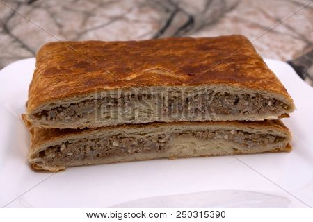 Woman Taking Baking Tray With Spinach Lasagna Out Of Oven