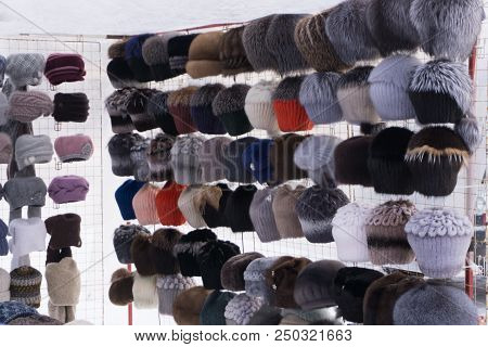 Rows Of Knitted Hats For Sale On A Market Stall In Warsaw, Poland. A Colourful Collection Of Bobble 
