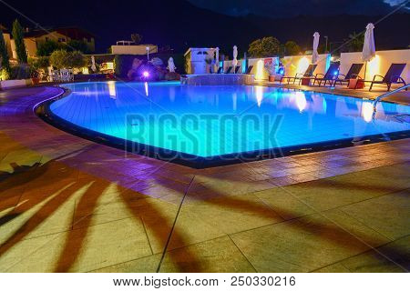 Swimming Pool At A Luxury Resort By Night In Lana