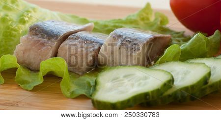 Appetizer Of Herring, Cucumbers, Tomatoes And Lettuce