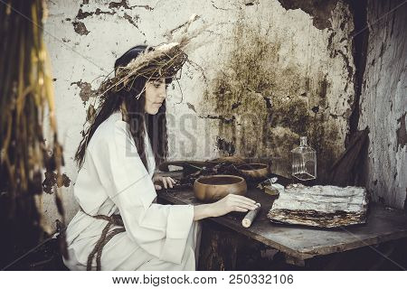 Girl Druid Healer With A Wreath Of Wild Flowers On His Head Holding A Bunch Of Herbs In His Hands An
