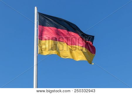 Berlin, Germany, July 14, 2018 - German Flag On The Flagpole Against The Blue Sky.