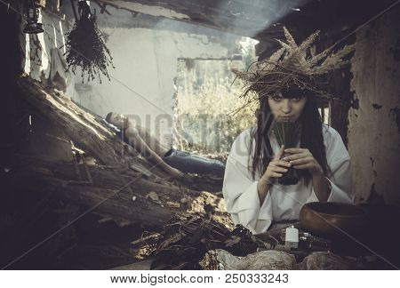 Girl Druid Healer With A Wreath Of Wild Flowers On His Head Holding A Bunch Of Herbs In His Hands An