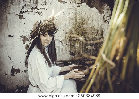 Girl Druid Healer With A Wreath Of Wild Flowers On His Head Holding A Bunch Of Herbs In His Hands An