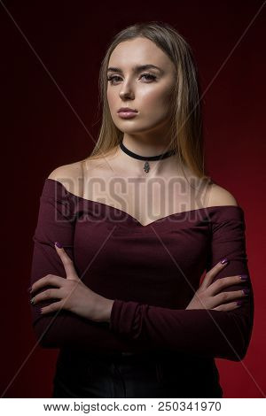 Portrait Of Sexy Woman In Studio Of Red Backgraund