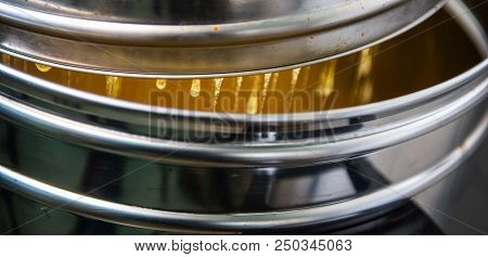 Strain The Poured Honey Through A Sieve. How To Harvest Honey. Filtering Raw Honey.