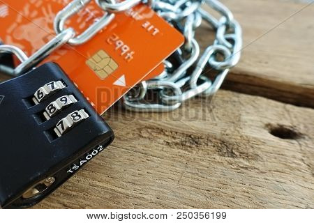 Credit Card Security Concept With Chain And Lock On Wooden Table