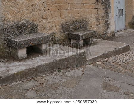 Grignan, France - July 16, 2018: Photography Showing Some Old Stone Bench. The Photography Was Taken