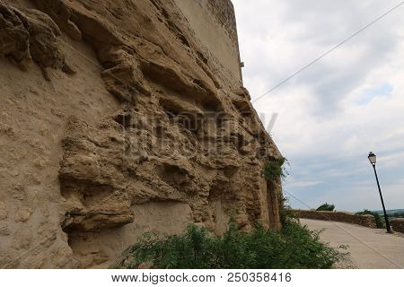 Grignan, France - July 16, 2018: Photography Showing An Old Wall Turning Into Stand. The Photography
