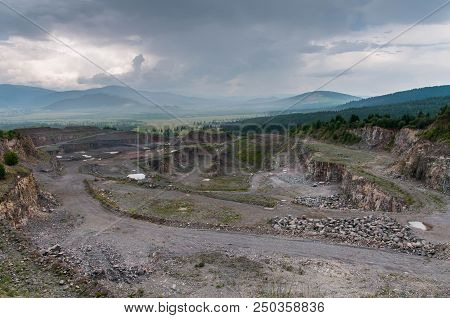 Abandoned Stone Pit, Quarry In Transylvania , Romania On Cloudy , Rainy Day.