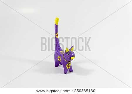 Perspective Shot Of Purple Cat Figure Wooden Carved Nicknack