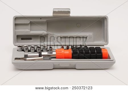 Reversible Screwdriver. A Set Of Screwdriver Nozzles In A Box On A White Background.