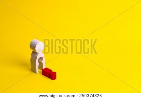 A Wooden Figure Of A Woman With A Void From Which A Red Child Fell. The Concept Of The Loss Of A Chi