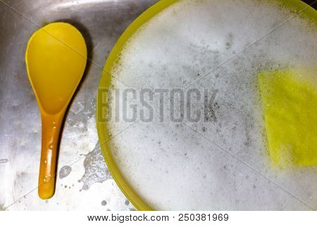 Dishwashing Liquid With Scotch Brite In The Basin In The Zink