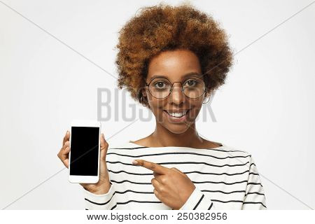 Happy African American Woman Wearing Roung Glasses, Isolated On Grey Background Demonstrating Blank 