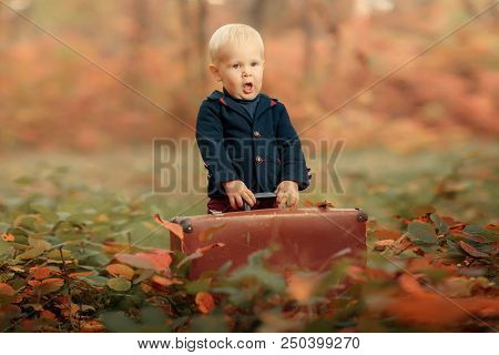 Adorable Boy On A Railway Station, Waiting For The Train With Suitcase