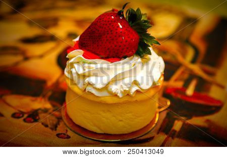 Delicious Cheese Cake, With Whip Cream And A Large Strawberry On Top Ready To Eat