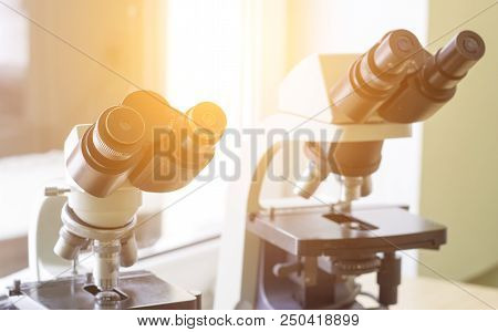 Two Microscopes Stand In The Laboratory, Close-up, Sunlight, Biotechnology