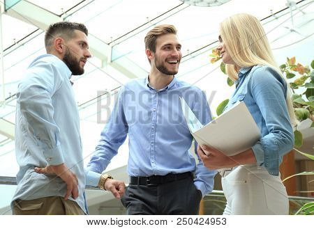 Young Modern Colleagues In Smart Casual Wear Having A Brainstorm Meeting While Standing In The Creat