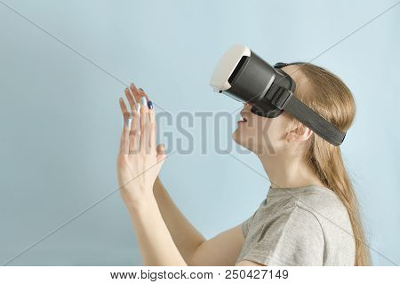 Yuong Woman With Glasses Of Virtual Reality. Blue Background