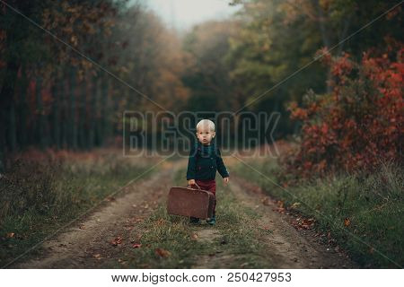 Adorable Boy Waiting For The Train With Suitcase