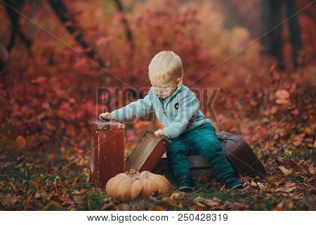 Adorable Boy Waiting For The Train With Suitcase