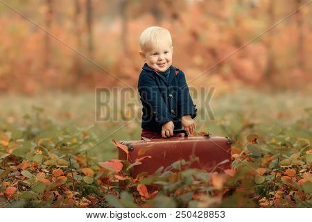 Adorable Boy On A Railway Station, Waiting For The Train With Suitcase