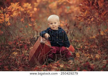 Adorable Boy On A Railway Station, Waiting For The Train With Suitcase