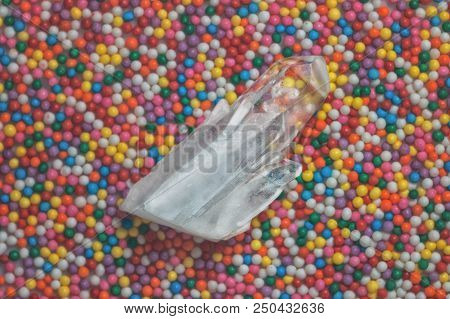 Clear Mystical Faceted Crystal Of Quartz Chalcedony On A Multicolored Background Close-up. Wonderful