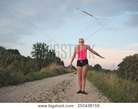 Teen Majorette Girl Twirling Baton Outdoors