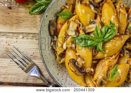 Pasta Conchiglioni With Mushrooms In A Vintage Bowl On A Dark Stone Or Concrete Background. Top View