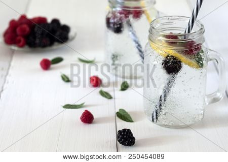 A Cooling Lemon Drink In A Glass Cup On A Wooden Table