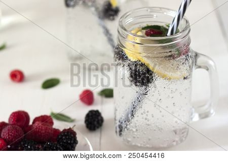 A Cooling Lemon Drink In A Glass Cup On A Wooden Table