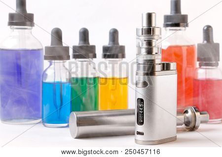 Electronic Cigarette And Bottles With Assorted Vape Liquid Within Vapor On White Background
