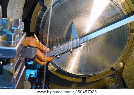 The Turner Measures The Parts After Machining On The Lathe