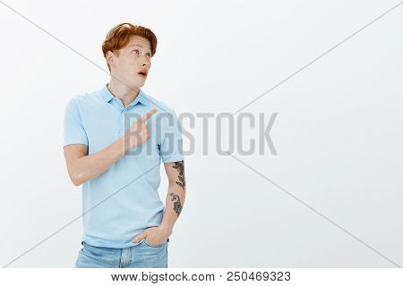 Never Saw Such Awesome Thing. Indoor Shot Of Shocked And Impressed Attractive Redhead Guy With Freck