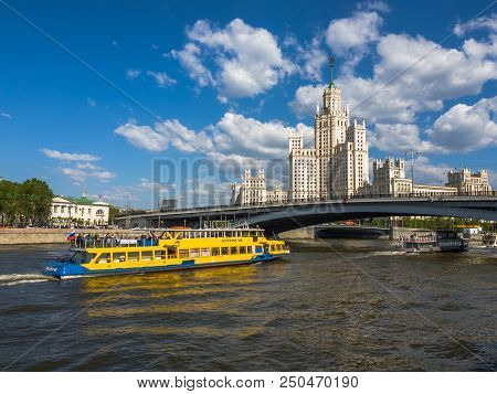 Moscow, Russia - May 12. 2018. Moskva - Ships Sail On River Past Skyscraper On A Kotelnicheskaya Emb