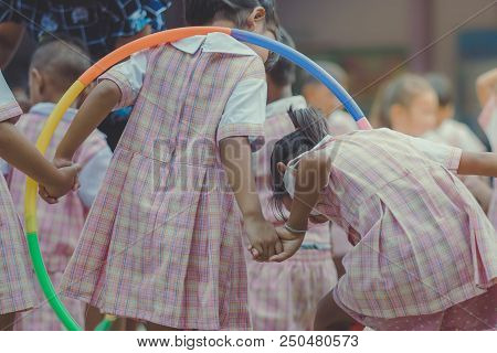 Young Kids Exercise With Hoola Hoop In The Morning.