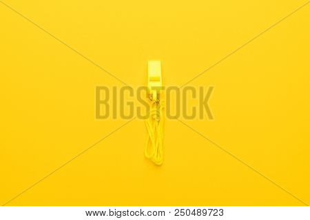 Plastic Referee Whistle. Referee Whistle On The Yellow. Plastic Referee Whistle In The Image Centre.