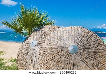 Sun Umbrellas And A View Of The Sea